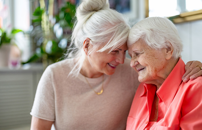 Smiling Resident with Caregiver