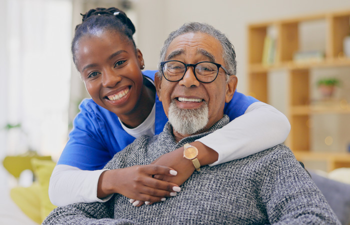 Caregiver with Resident, both smiling